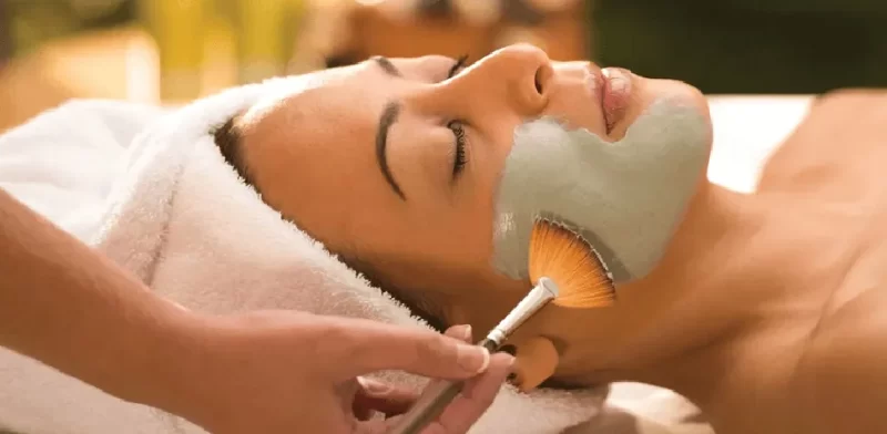 Clay mask application process during facial treatments.