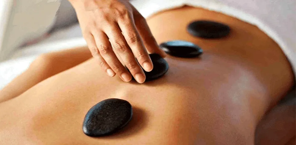 Hot Stone massage in Danang illustrating stone placement on the back.